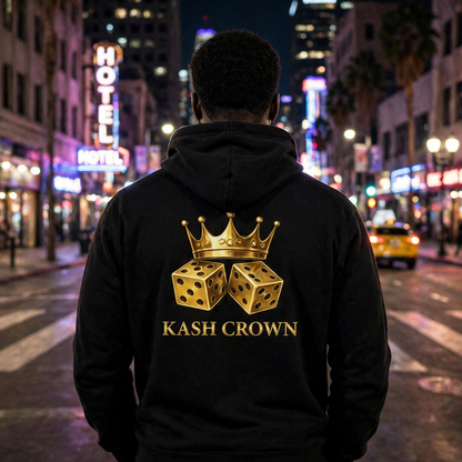 Back view of the black KASH CROWN Crown & Dice Hoodie worn on a city street at night, gold crown and dice graphic across the back